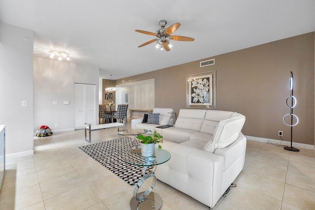 living room with ceiling fan and light tile patterned floors