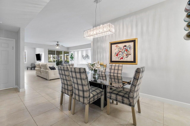 dining area featuring ceiling fan with notable chandelier and light tile patterned floors