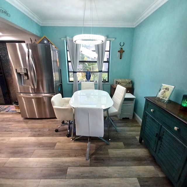 dining space featuring crown molding and wood-type flooring