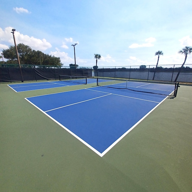 view of tennis court featuring basketball court