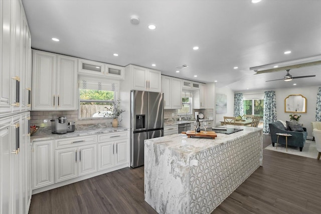 kitchen featuring white cabinets, stainless steel appliances, and a healthy amount of sunlight