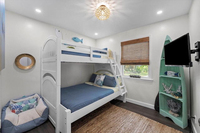 bedroom with dark hardwood / wood-style floors