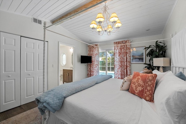 bedroom featuring beam ceiling, an inviting chandelier, ensuite bath, wood-type flooring, and a closet