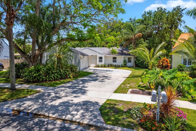 view of front of house featuring a garage and a front lawn