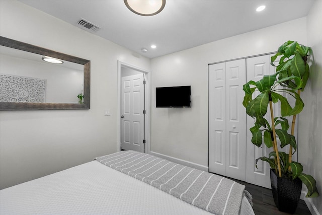 bedroom featuring a closet and dark wood-type flooring