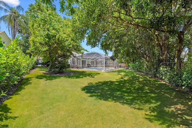 view of yard with glass enclosure