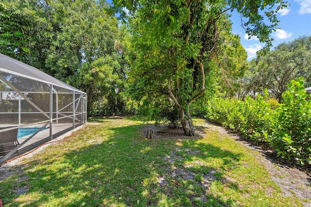 view of yard featuring glass enclosure