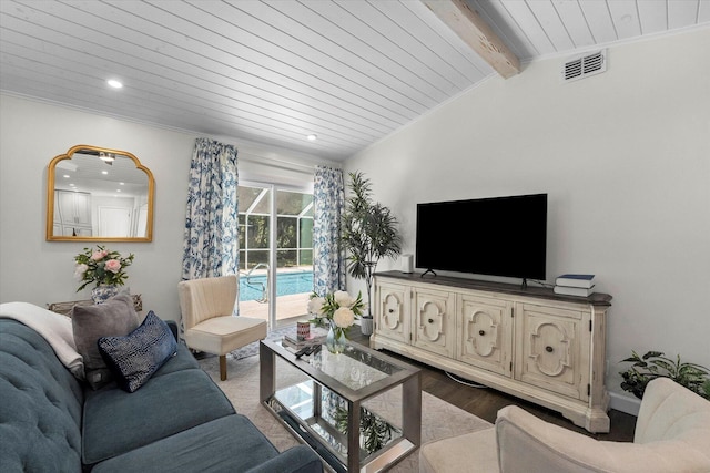 living room with hardwood / wood-style floors and lofted ceiling with beams