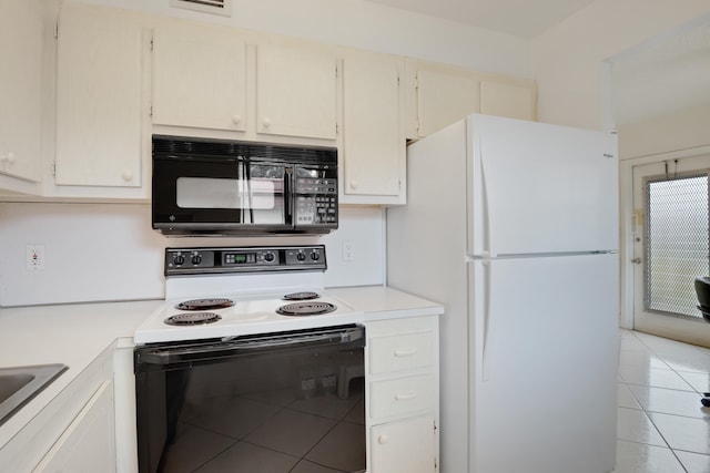 kitchen with light tile patterned flooring and white appliances