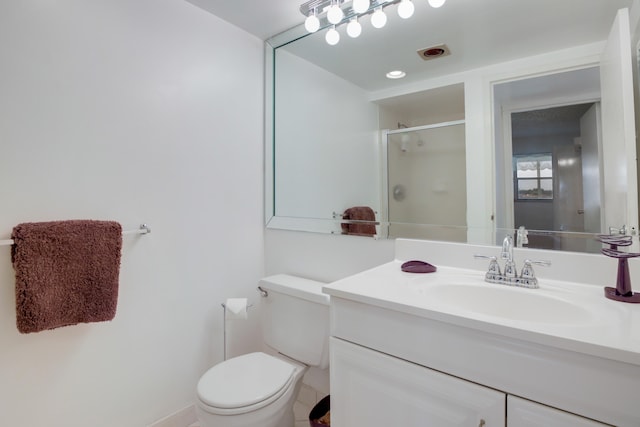 bathroom with walk in shower, vanity, and toilet