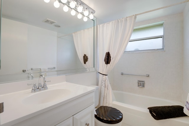 full bathroom with shower / bath combo, vanity, and toilet