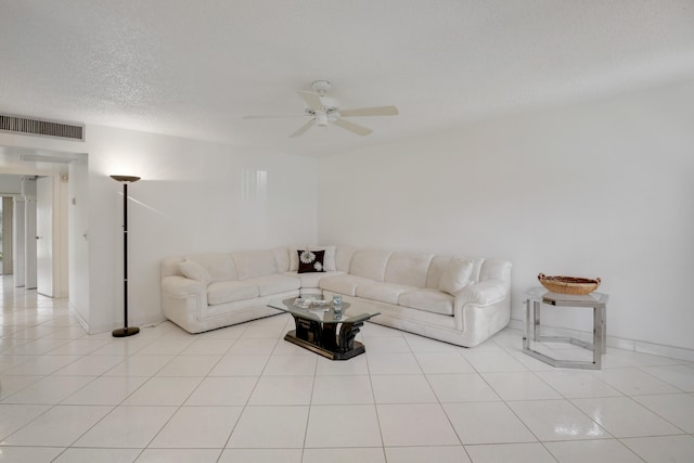 tiled living room with a textured ceiling and ceiling fan