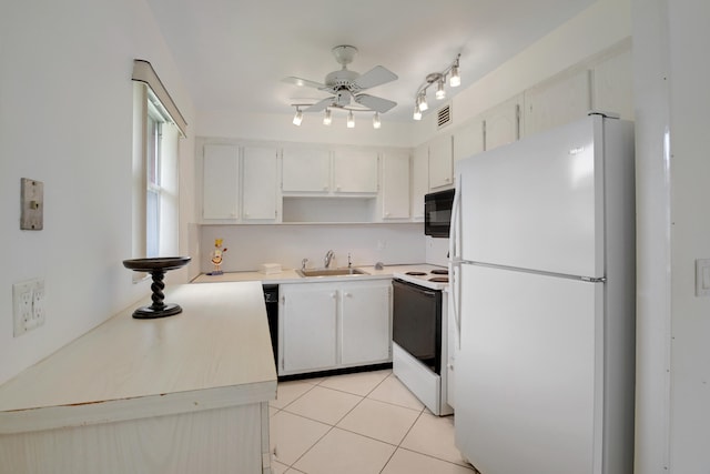 kitchen featuring light tile patterned floors, white cabinets, sink, and white appliances