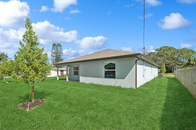 rear view of property featuring a yard