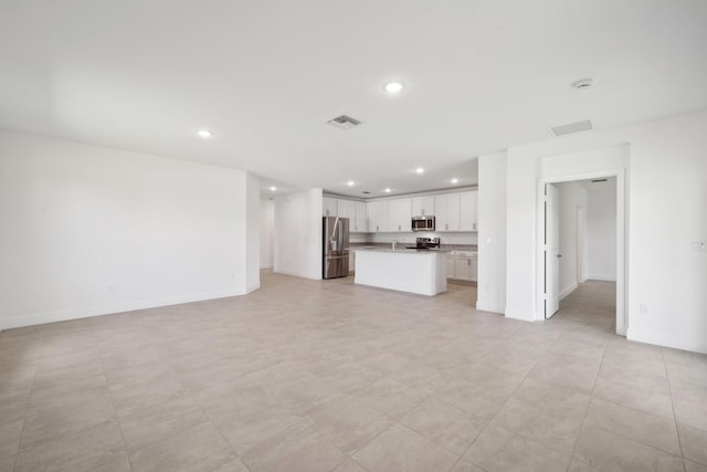 unfurnished living room with sink