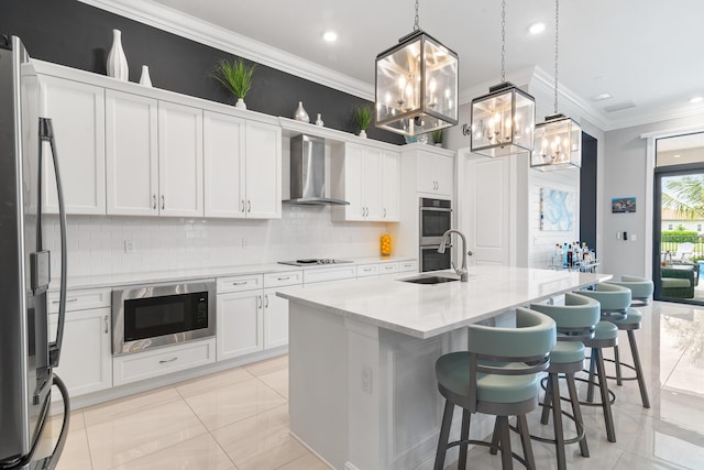 kitchen featuring stainless steel appliances, decorative backsplash, ornamental molding, a sink, and wall chimney exhaust hood