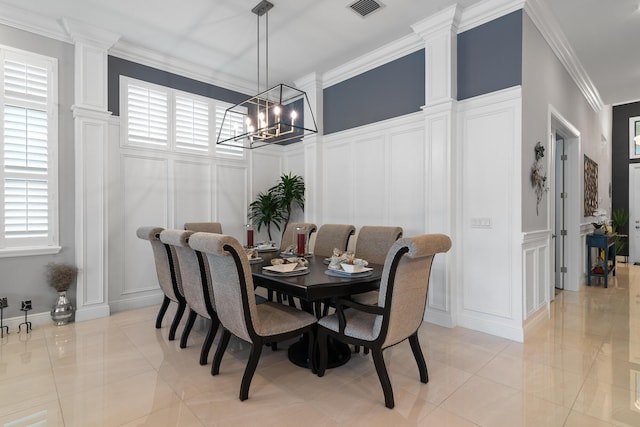 dining area with ornamental molding, a healthy amount of sunlight, a decorative wall, and visible vents