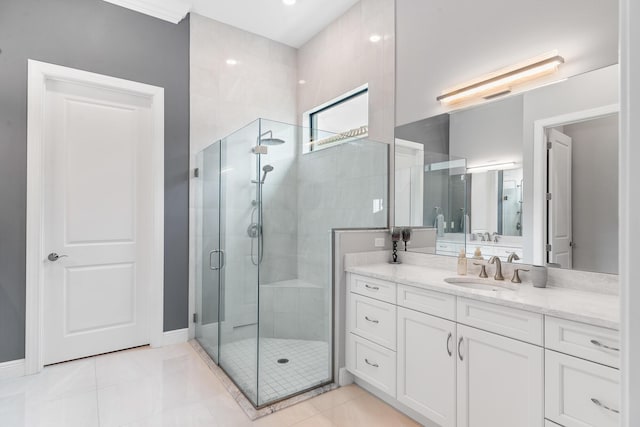 bathroom with tile patterned floors, a shower stall, baseboards, and vanity