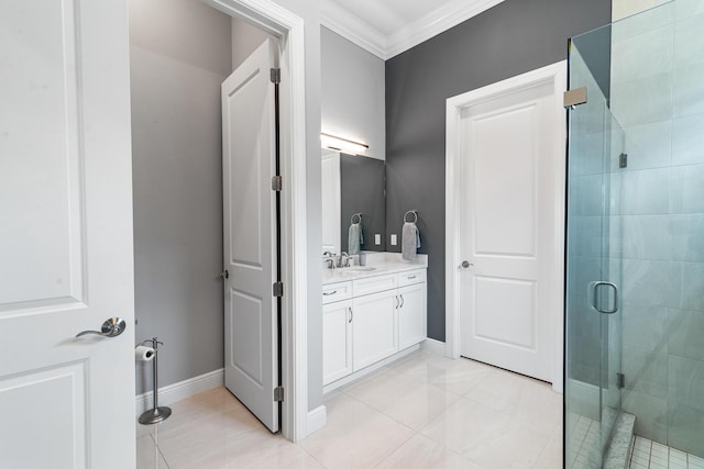 bathroom with ornamental molding, a shower stall, vanity, tile patterned flooring, and baseboards