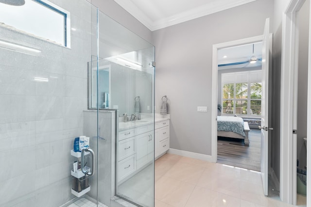 ensuite bathroom with a stall shower, baseboards, ornamental molding, tile patterned floors, and vanity