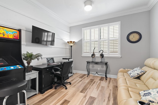 office area featuring light wood-style floors, baseboards, and ornamental molding