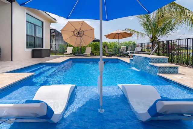 view of swimming pool with a fenced in pool, a lanai, a patio area, and fence