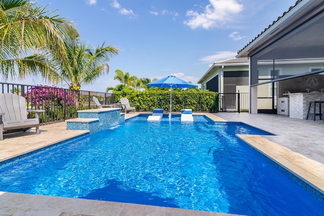 view of pool with a patio area, fence, outdoor dry bar, and a fenced in pool