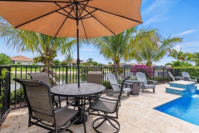 view of patio with outdoor dining space and a fenced in pool