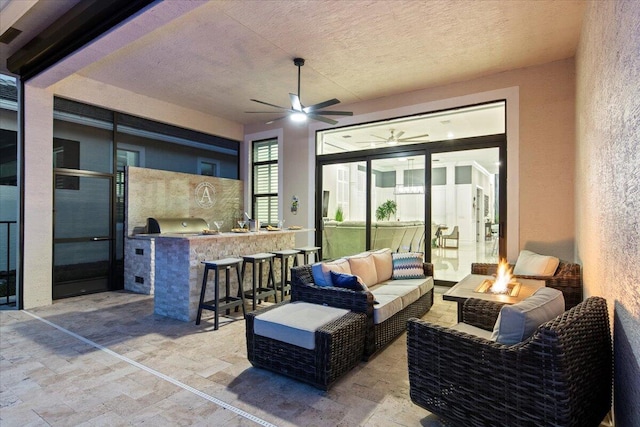 view of patio featuring an outdoor living space with a fire pit, outdoor dry bar, grilling area, ceiling fan, and exterior kitchen