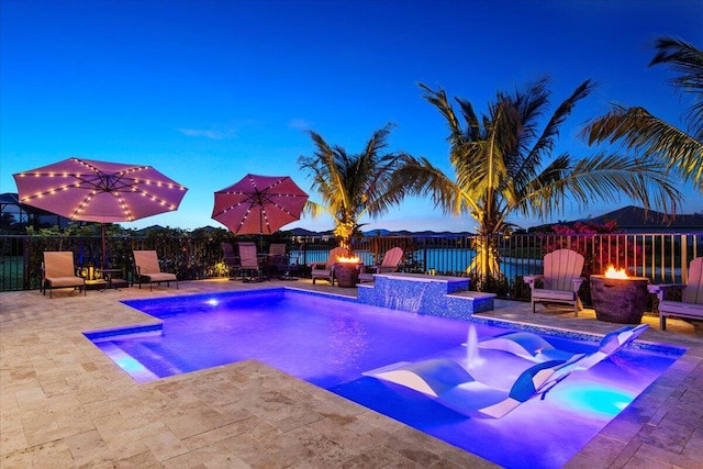 view of swimming pool with a hot tub, a fire pit, and a patio