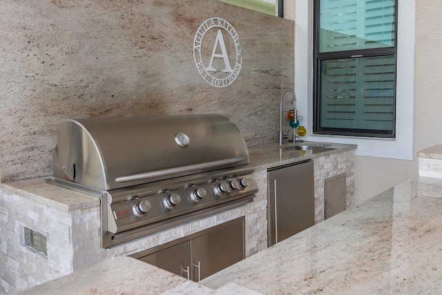 view of patio featuring an outdoor kitchen, area for grilling, and a sink