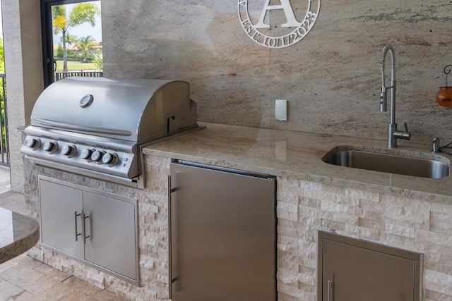 view of patio featuring exterior kitchen, area for grilling, a sink, and fence