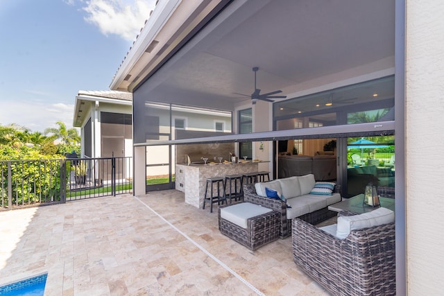 view of patio / terrace with a sunroom, ceiling fan, outdoor dry bar, and an outdoor hangout area