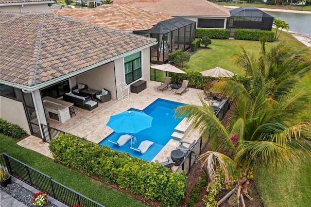 view of swimming pool featuring a yard, outdoor lounge area, a patio area, fence, and a lanai