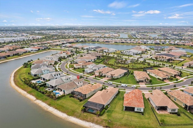 drone / aerial view featuring a water view and a residential view