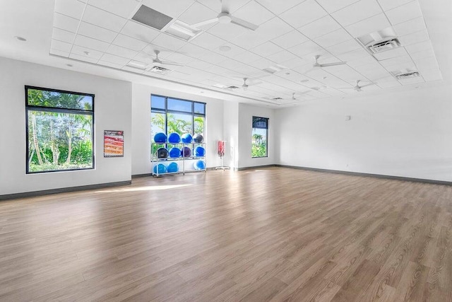 spare room with a ceiling fan, baseboards, and wood finished floors