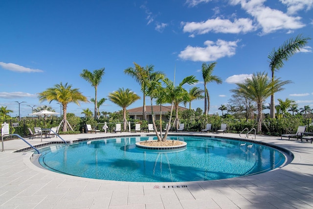 community pool featuring a patio area and fence