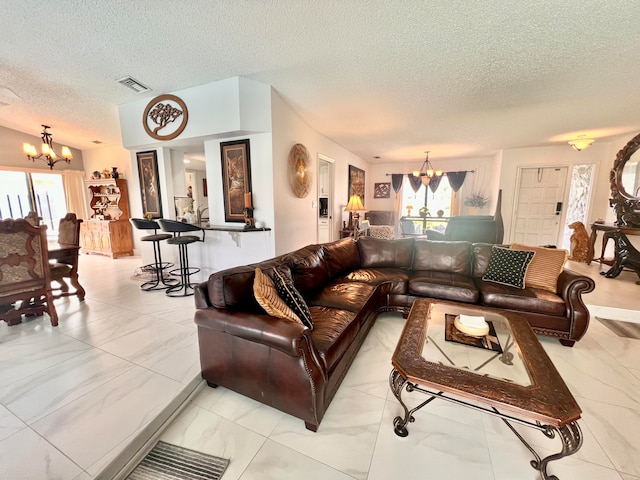 tiled living room featuring lofted ceiling, a chandelier, and a textured ceiling