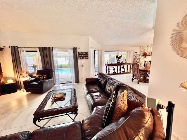 tiled living room with a textured ceiling and a wealth of natural light