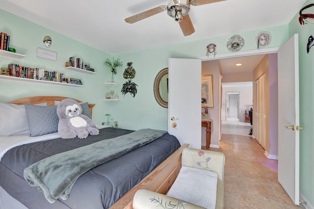 bedroom featuring a closet, ceiling fan, and light tile patterned flooring