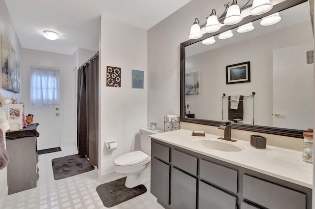 bathroom with vanity, toilet, and curtained shower