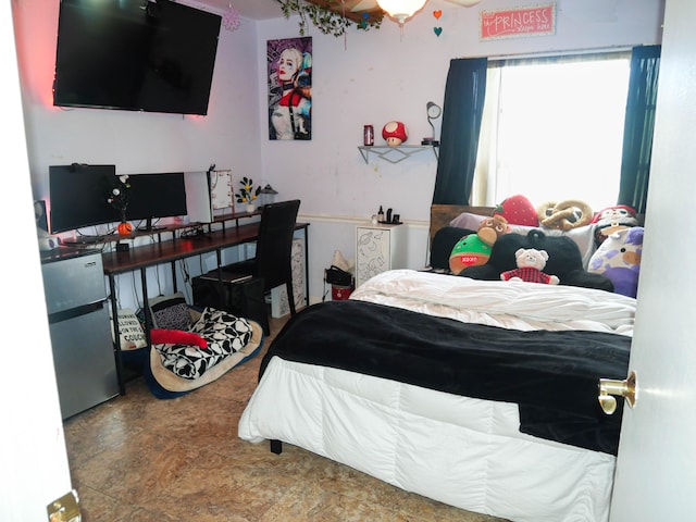 bedroom featuring stainless steel fridge and ceiling fan