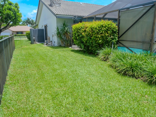 view of yard featuring glass enclosure