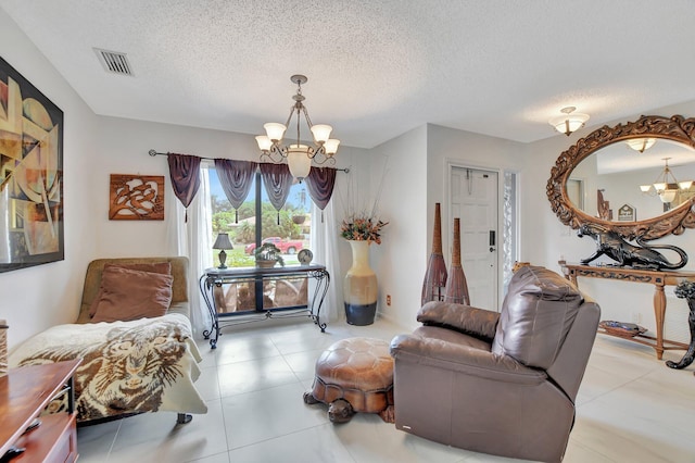 sitting room with a textured ceiling and a notable chandelier