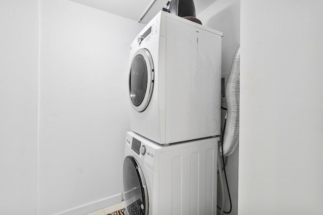 washroom featuring stacked washer / drying machine