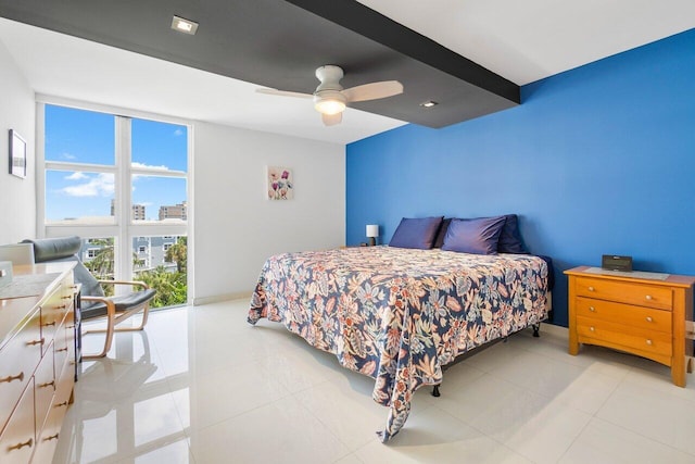 tiled bedroom featuring a wall of windows and ceiling fan