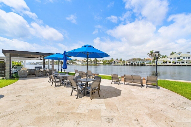 view of patio / terrace with exterior kitchen and a water view