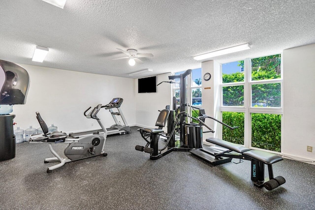 exercise area featuring a textured ceiling and ceiling fan