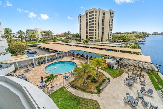 view of pool featuring a patio area and a water view