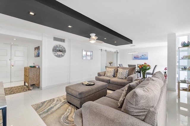 living room featuring light tile patterned flooring and ceiling fan